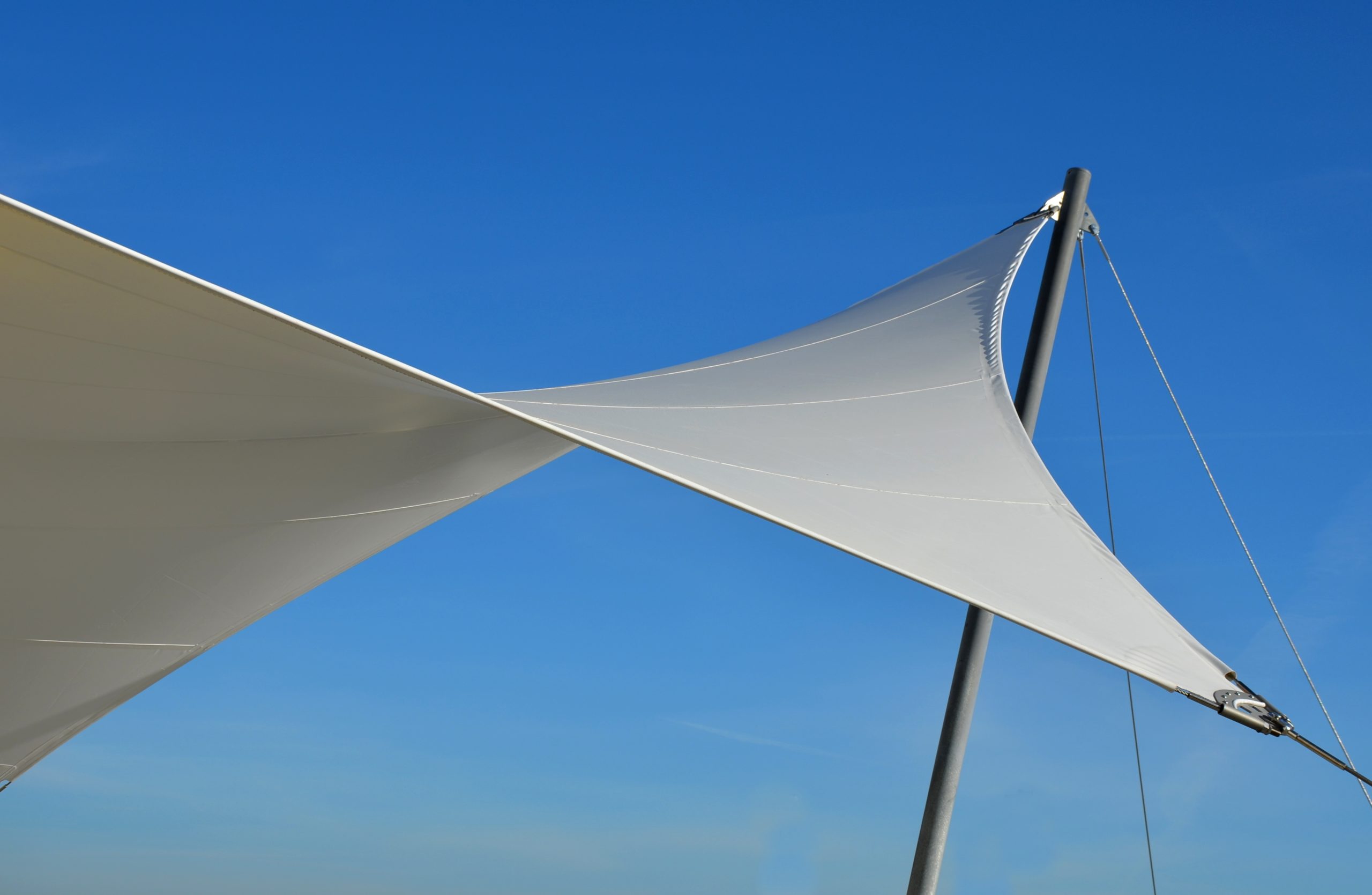 White,Tarpaulin,Taut,,Shading,From,The,Sun,And,Rain,Over